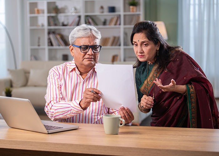 Financial advisor helping senior client review life insurance policy options.